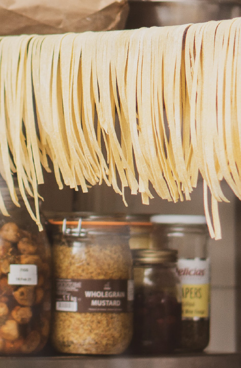 Photo of Different Pasta Shapes in a Store Window